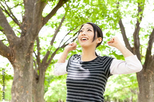 young asian woman relaxing in the forest
