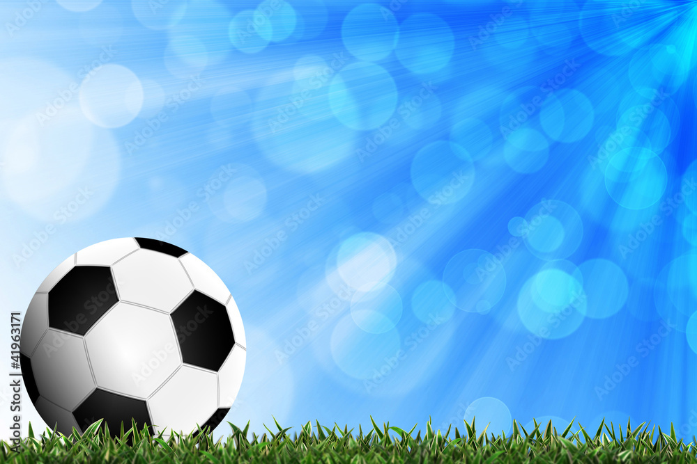 Fototapeta premium Football in green grass with background colorful