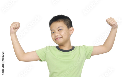 portrait of an innocent little boy flexing biceps