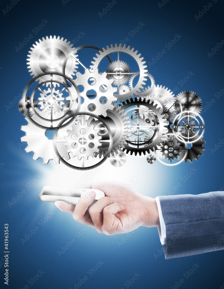 businessman holding mobile phone with gear wheel businessman holding mobile phone with gear wheel