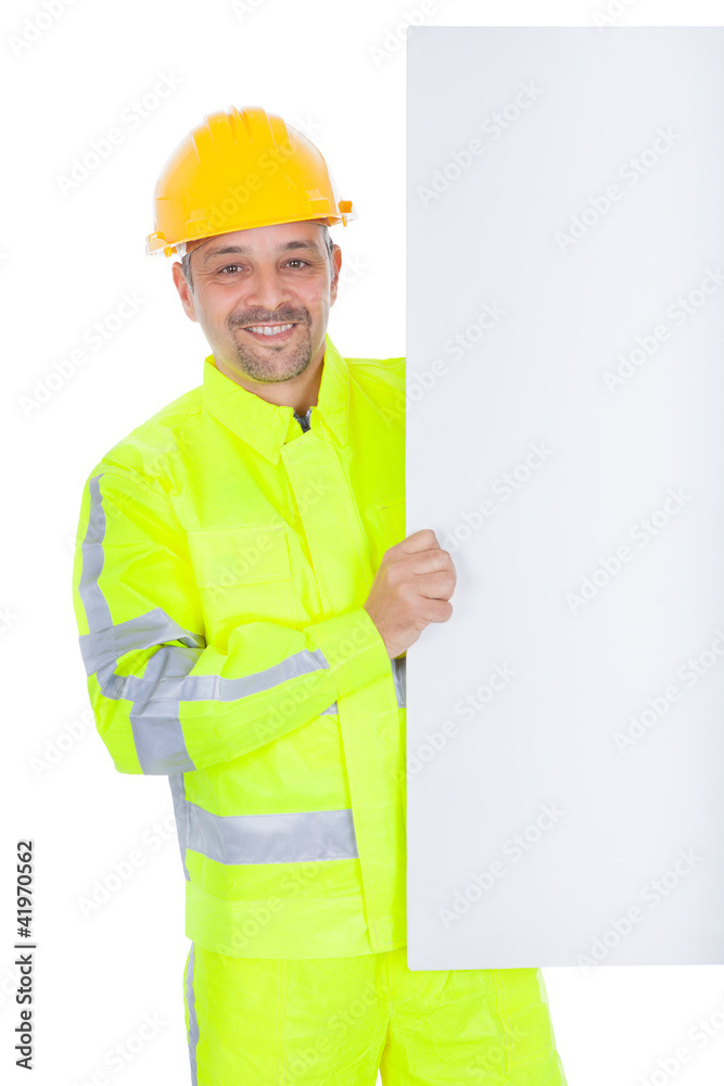 Worker in safety jacket presenting empty board Worker in safety jacket presenting empty board