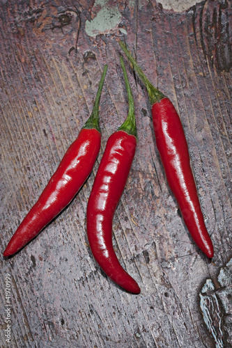 Red andpeppers on a old cracked wooden background