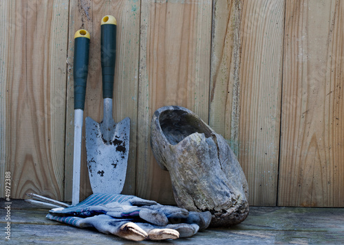 garden tools gloves and wooden shoe photo