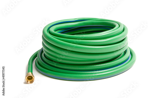 Rolled up garden hose isolated on white photo