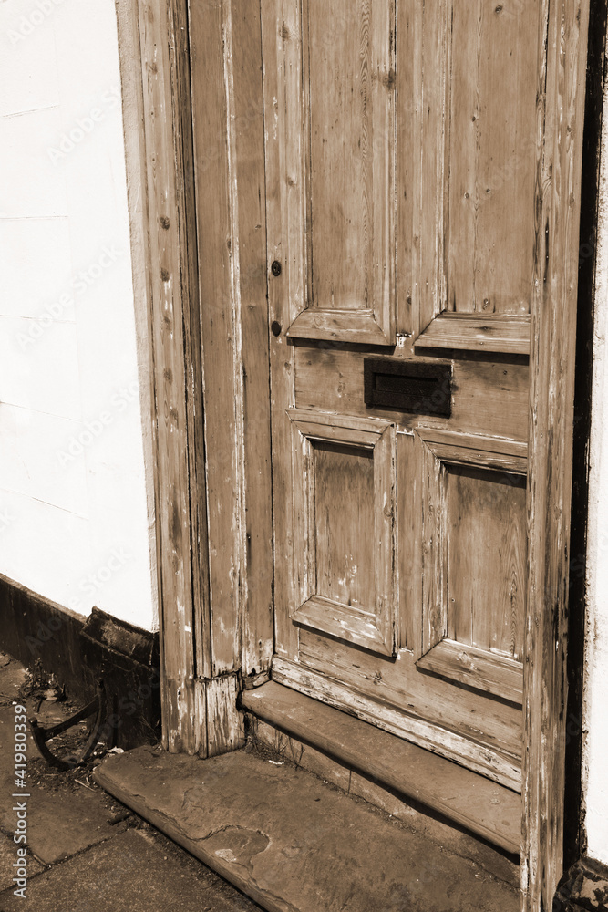 Wooden door with a mail slot in sepia Wooden door with a mail slot in sepia