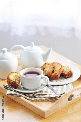 Tray with raisin cake and tea