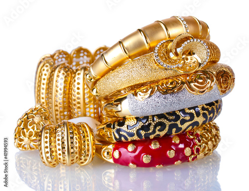 Beautiful golden bracelets isolated on white