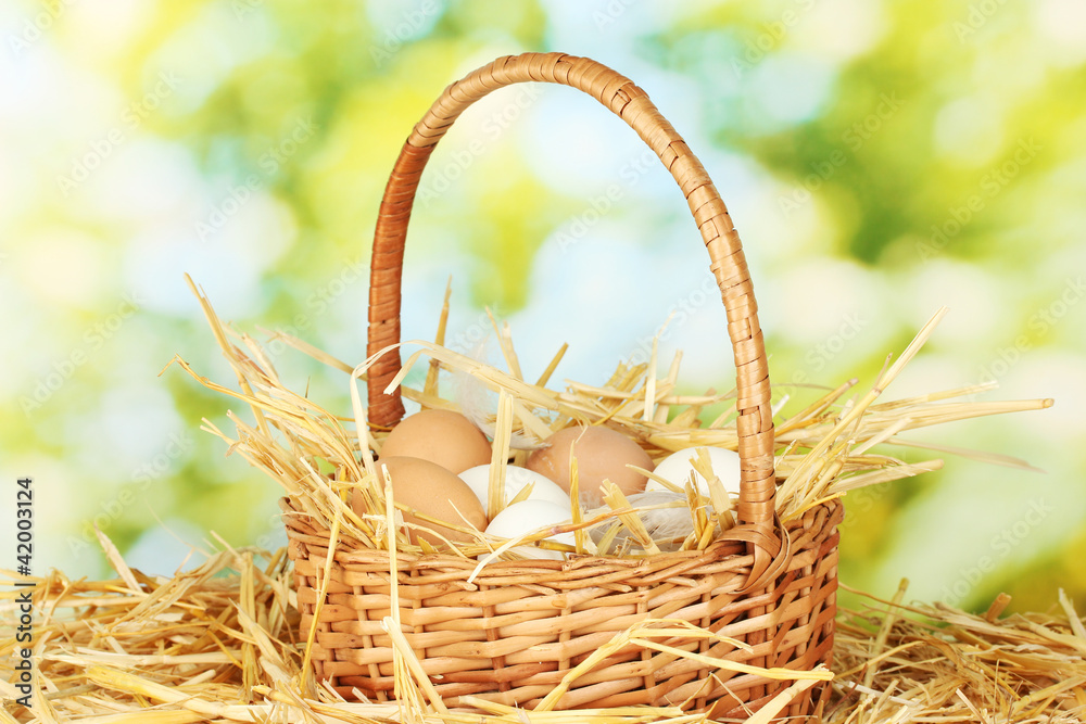 white and brown eggs in a wicker bascet