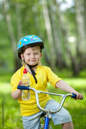 Portrait of a cute kid on bicycle