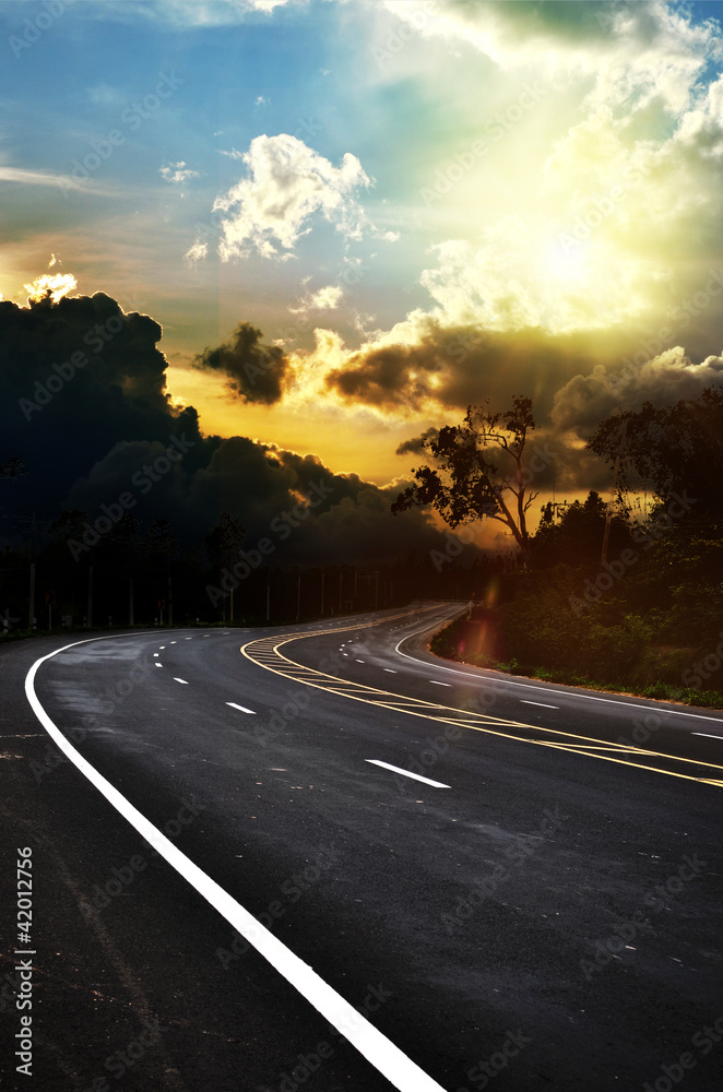 asphalt road and dark thunder clouds over it asphalt road and dark thunder clouds over it