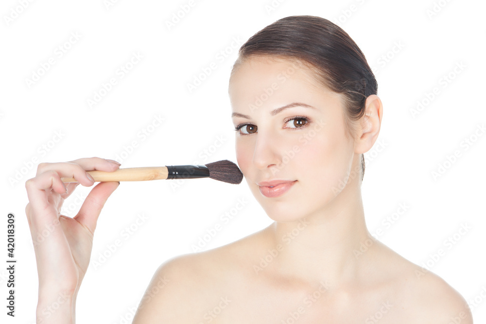 Beautiful young brunette woman holds the make-up brush Beautiful young brunette woman holds the make-up brush