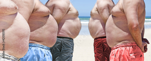 Five very obese fat men on the beach photo