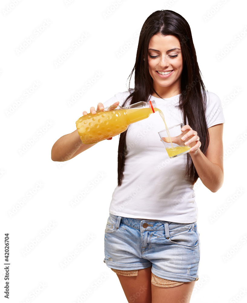 portrait of young woman pouring orange juice on glass over white portrait of young woman pouring orange juice on glass over white