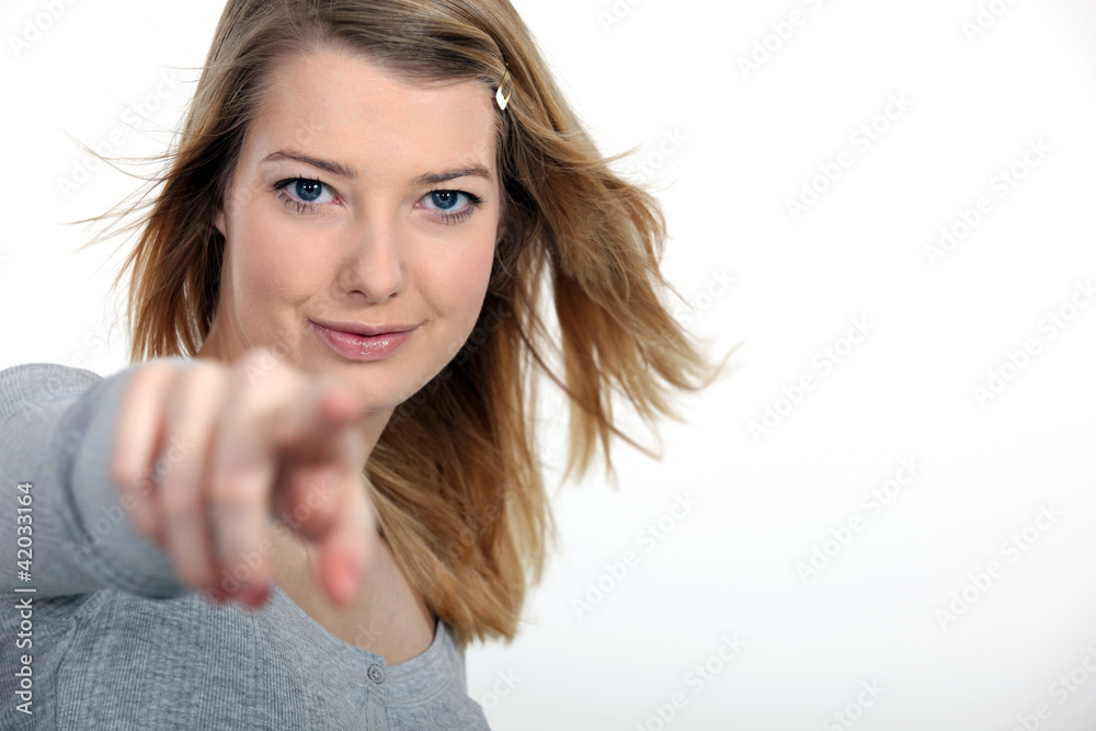 A cute blond pointing at the camera. A cute blond pointing at the camera.