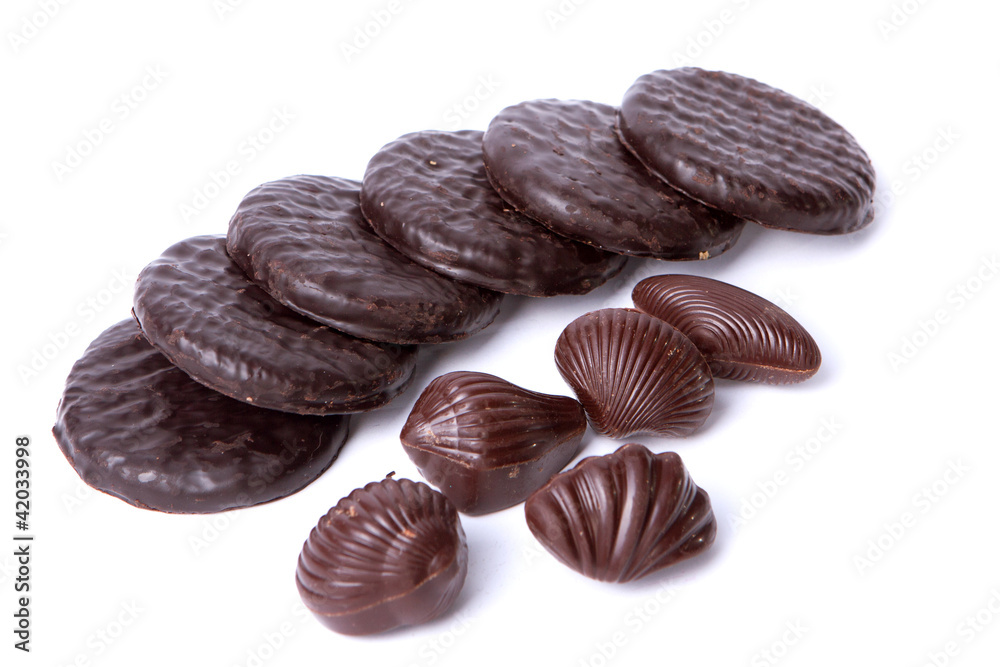 Six cookies and five chocolate on the white bacground Six cookies and five chocolate on the white bacground