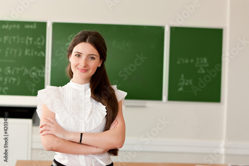 teacher on background of blackboard