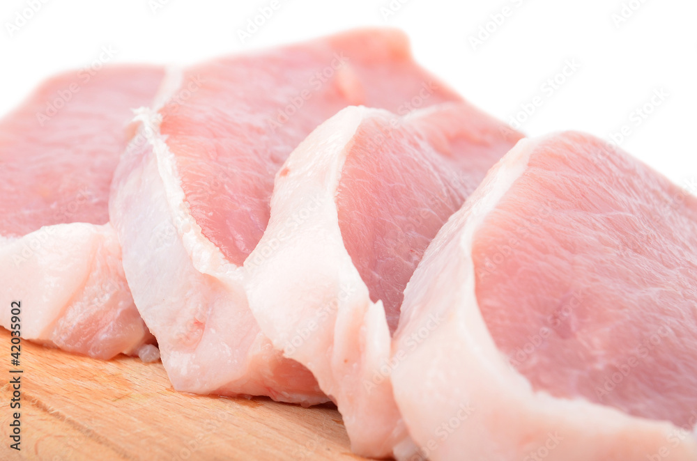 Raw meat steaks on wooden board, isolated on white background Raw meat steaks on wooden board, isolated on white background