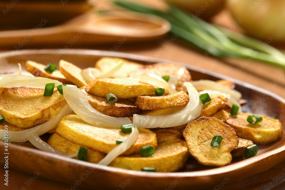 Homemade crispy fried potato slices with fried onion