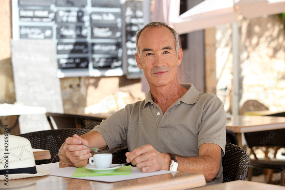 Man drinking coffee outside a cafe Man drinking coffee outside a cafe