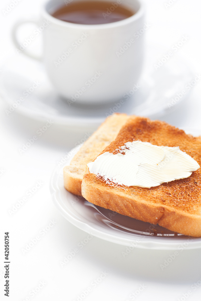 tea and toast with butter isolated on white tea and toast with butter isolated on white
