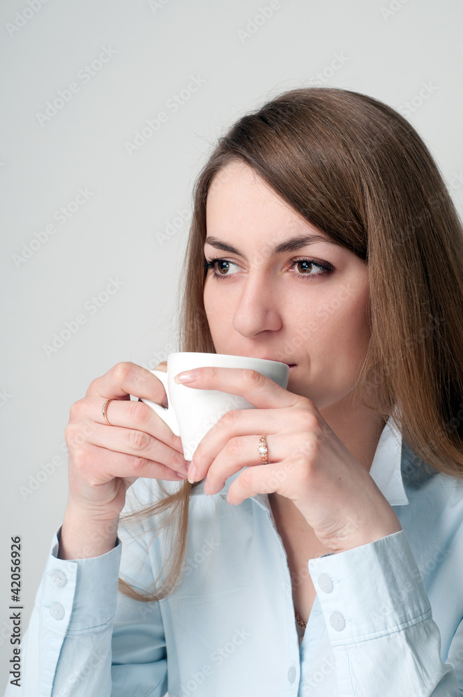 Girl with a cup of coffee drinkers Girl with a cup of coffee drinkers