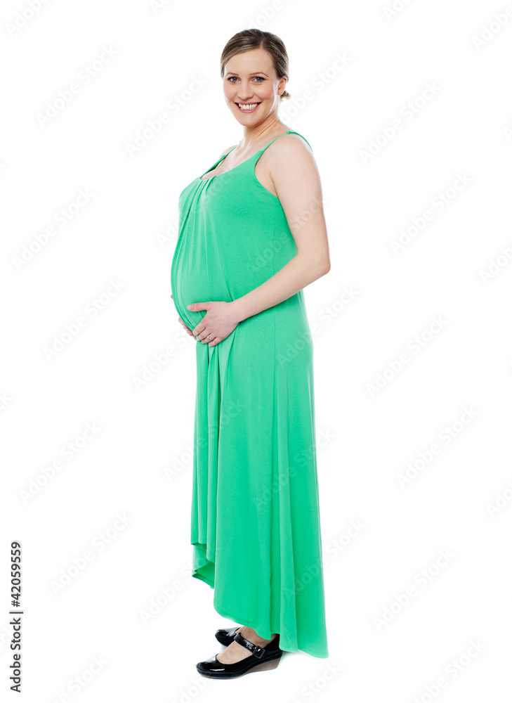 Pregnant woman posing in trendy fashion wear Pregnant woman posing in trendy fashion wear
