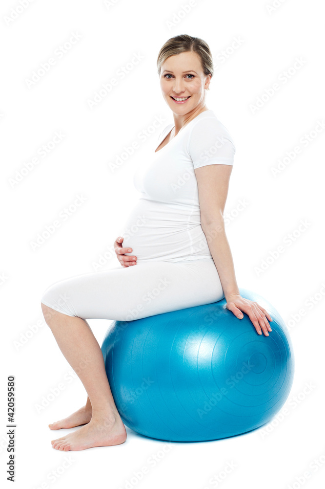 Pregnant lady sitting on exercise ball Pregnant lady sitting on exercise ball