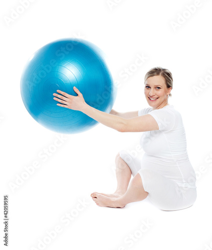 Pregnant woman playing with exercise ball