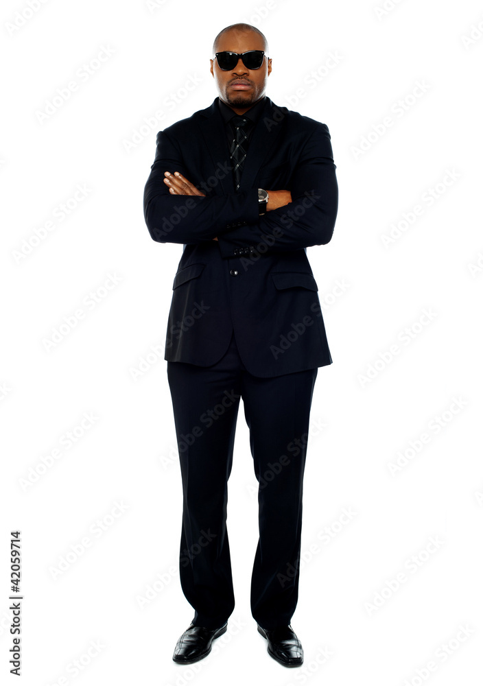 African corporate man standing with crossed arms