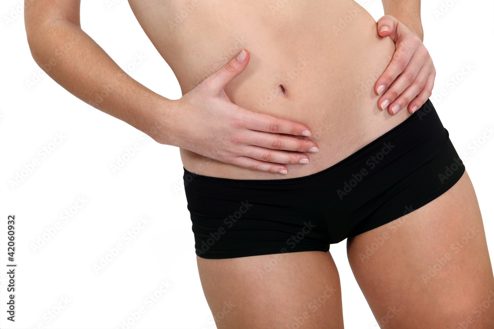 Closeup on a young woman wearing black hip-hugger Closeup on a young woman wearing black hip-hugger