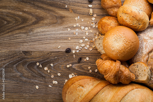 assortment of baked bread on wood table