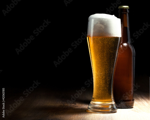 beer glass and bottle on a wooden table