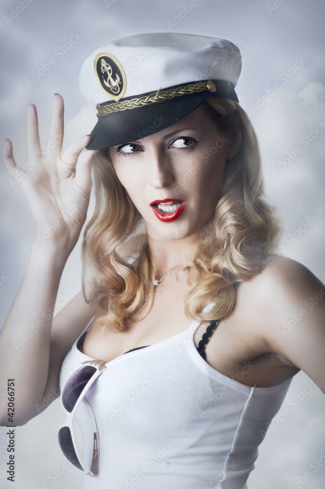 Pin-up girl in captain cap and sun glasses Pin-up girl in captain cap and sun glasses