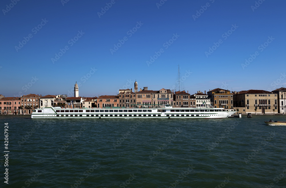 Long and narrow passenger ship moored in Venice