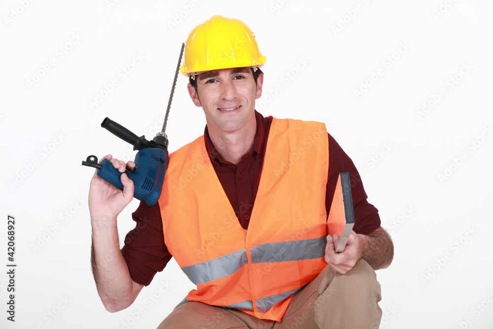 Construction worker with a masonry drill Construction worker with a masonry drill