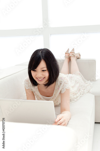 Beautiful young woman using a laptop computer. Portrait of asian