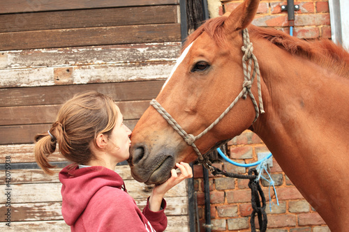 Fototapeta Naklejka Na Ścianę i Meble -  tender moment between a woman and her horse