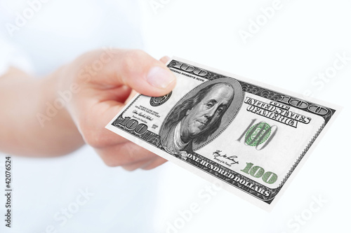 one hundred dollars banknote holded by hand over white