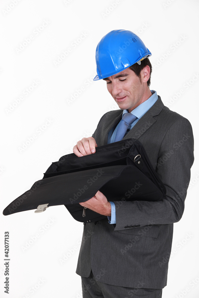 Engineer looking for something in his briefcase Engineer looking for something in his briefcase