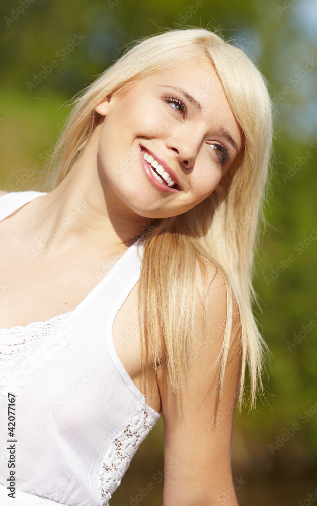 close-up portrait of beautiful young blond woman in white blouse close-up portrait of beautiful young blond woman in white blouse