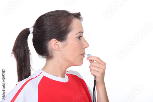 Woman blowing a whistle