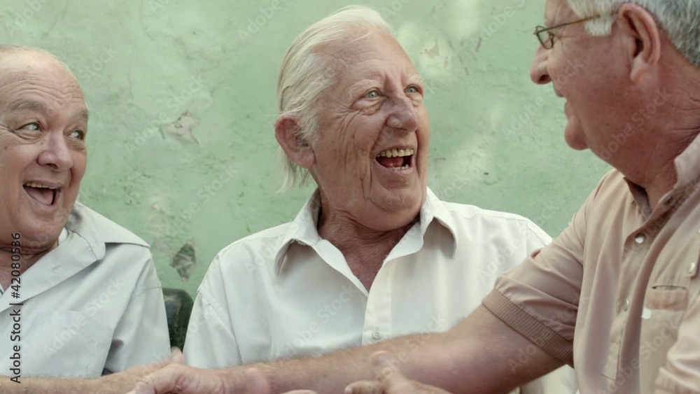 Group of happy elderly men laughing and talking