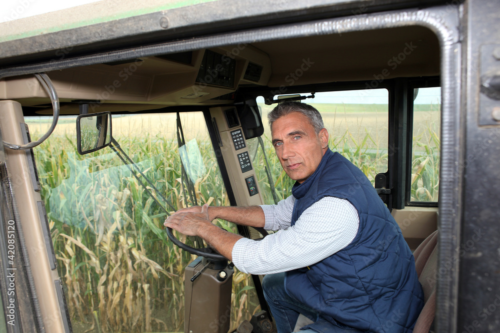 Obraz premium Farmer driving a tractor
