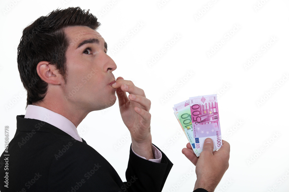 Businessman wondering what to do with his money Businessman wondering what to do with his money