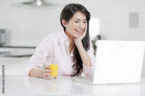Girl chatting with friends on laptop