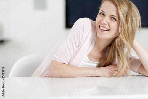 Young woman sat at table