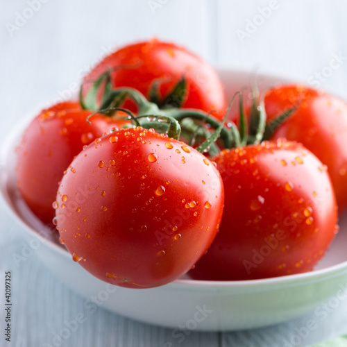 Fresh tomatoes in a white bowl