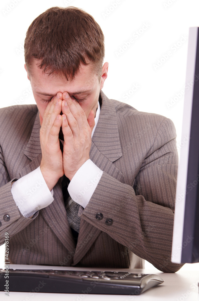 tired businessman sitting at a computer tired businessman sitting at a computer