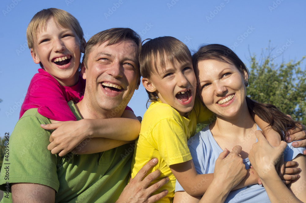 Happy Caucasian mom and father together with his sons play the f Happy Caucasian mom and father together with his sons play the f
