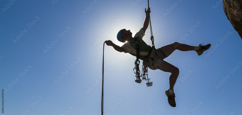 Climber rappelling from the summit. Climber rappelling from the summit.